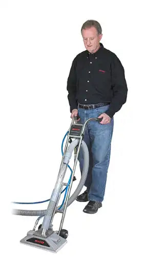 Technician operating Bonzer extractor on carpet using ergonomic handle