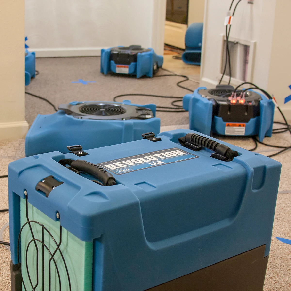 Dri-Eaz Revolution LGR Dehumidifier running in residential water extraction setup