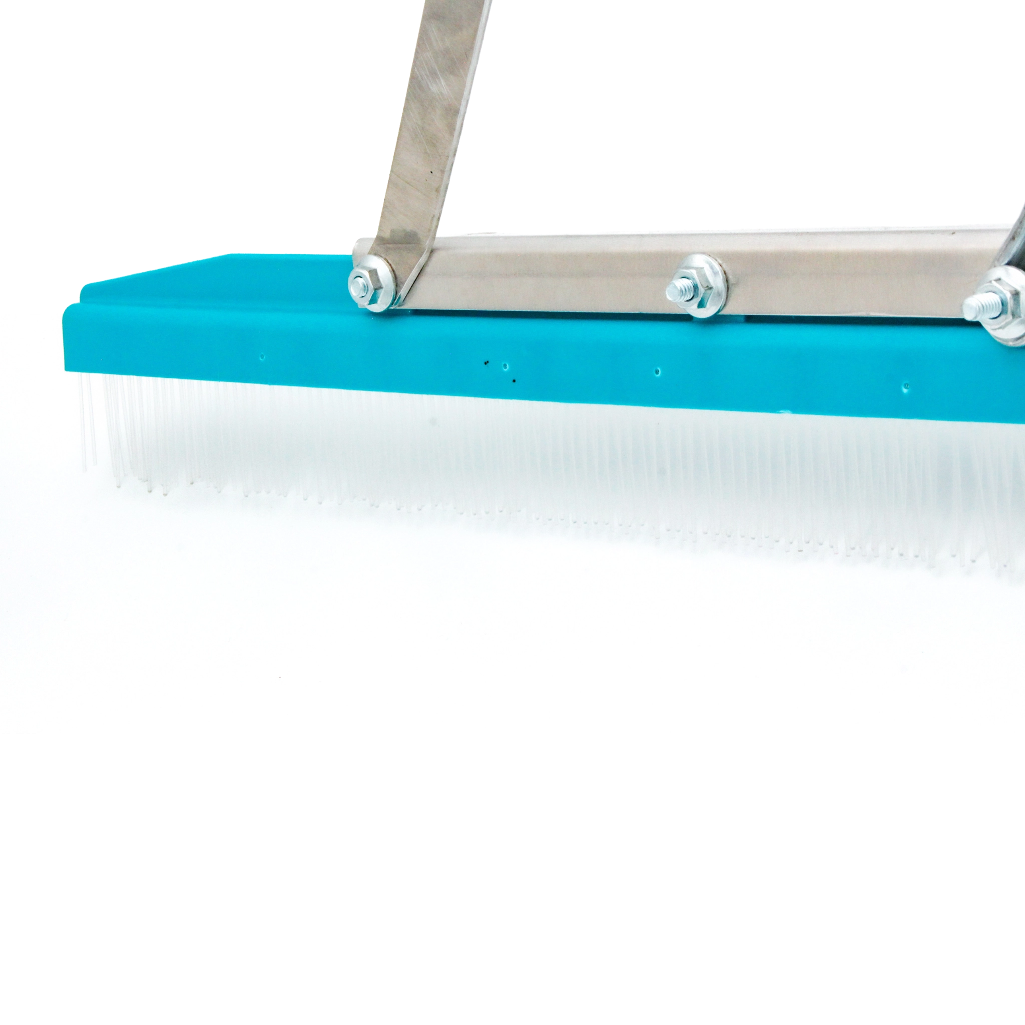 zoomed in on left edge of rake showing end of grooming head and tine detail