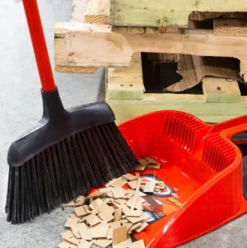 Libman Angle Broom sweeping debris into dustpan during cleanup
