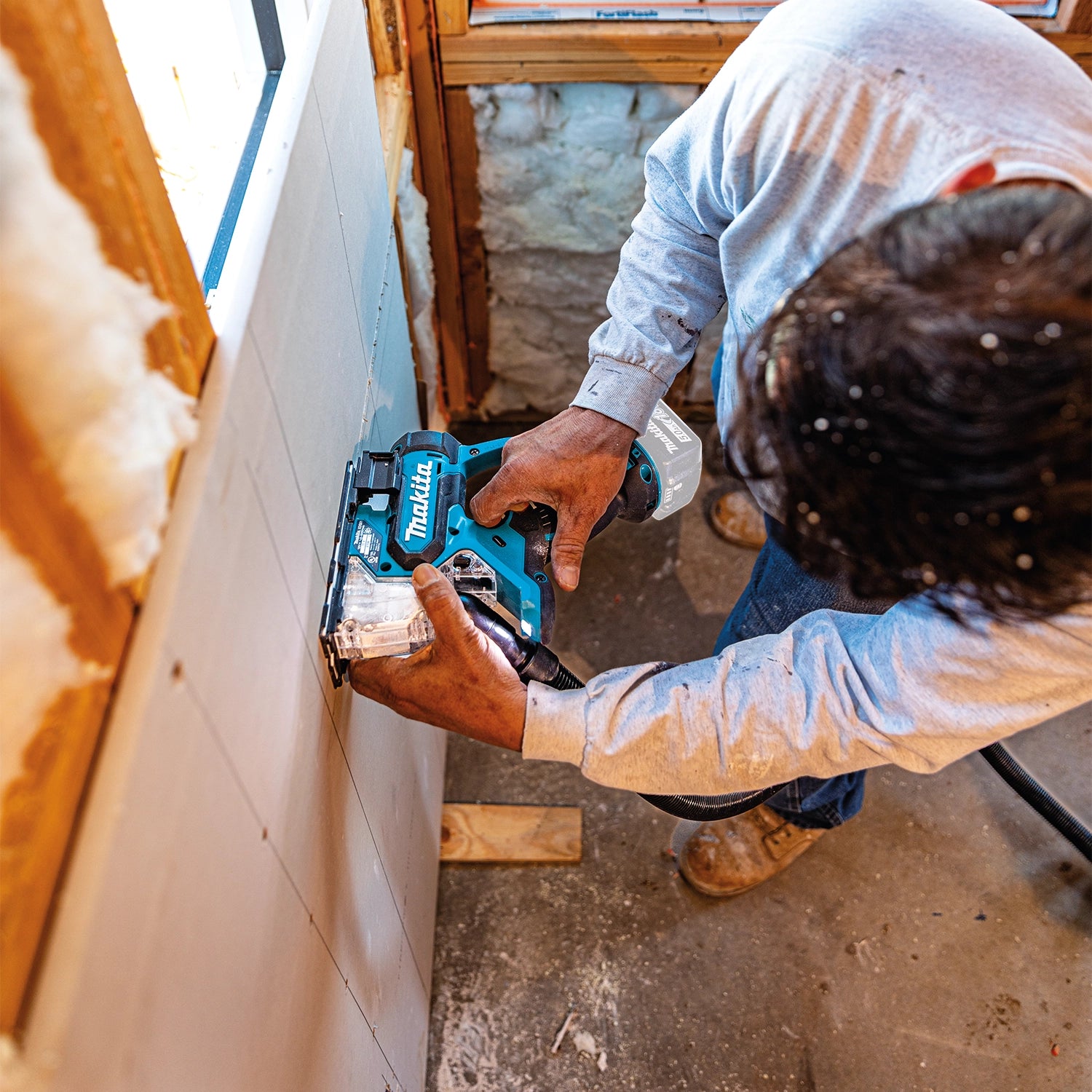 Makita drywall saw in use cutting drywall between wall studs