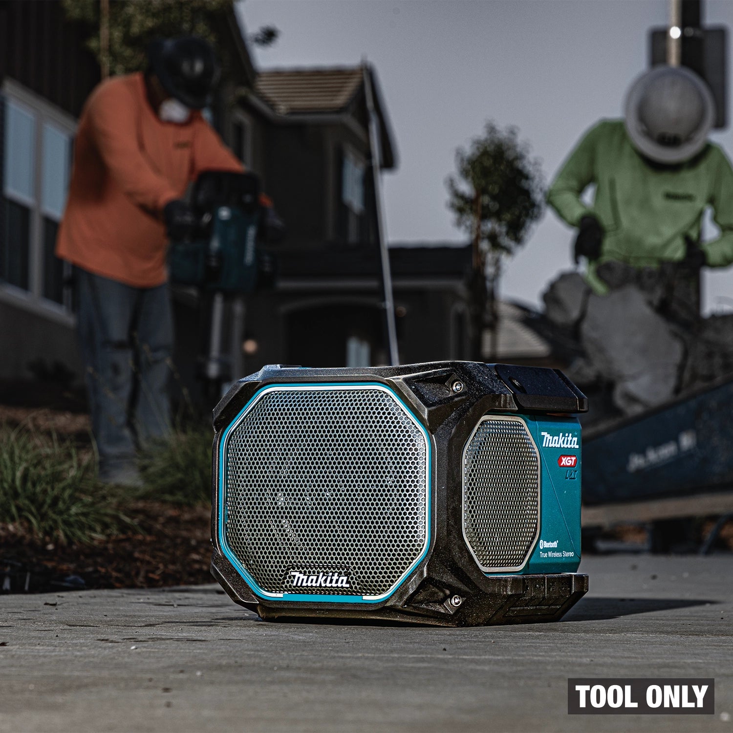 Angled view of Makita GRM05 speaker in use on active jobsite