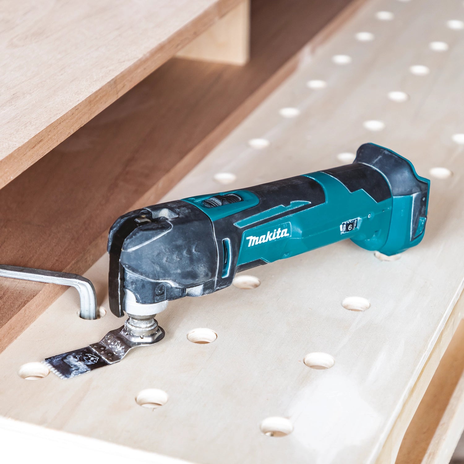 Makita XMT03Z multi-tool in use on active jobsite during remodel work