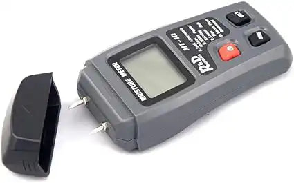 R&D MT-10 moisture meter laid flat with cap removed, showing dual metal probes and LCD display