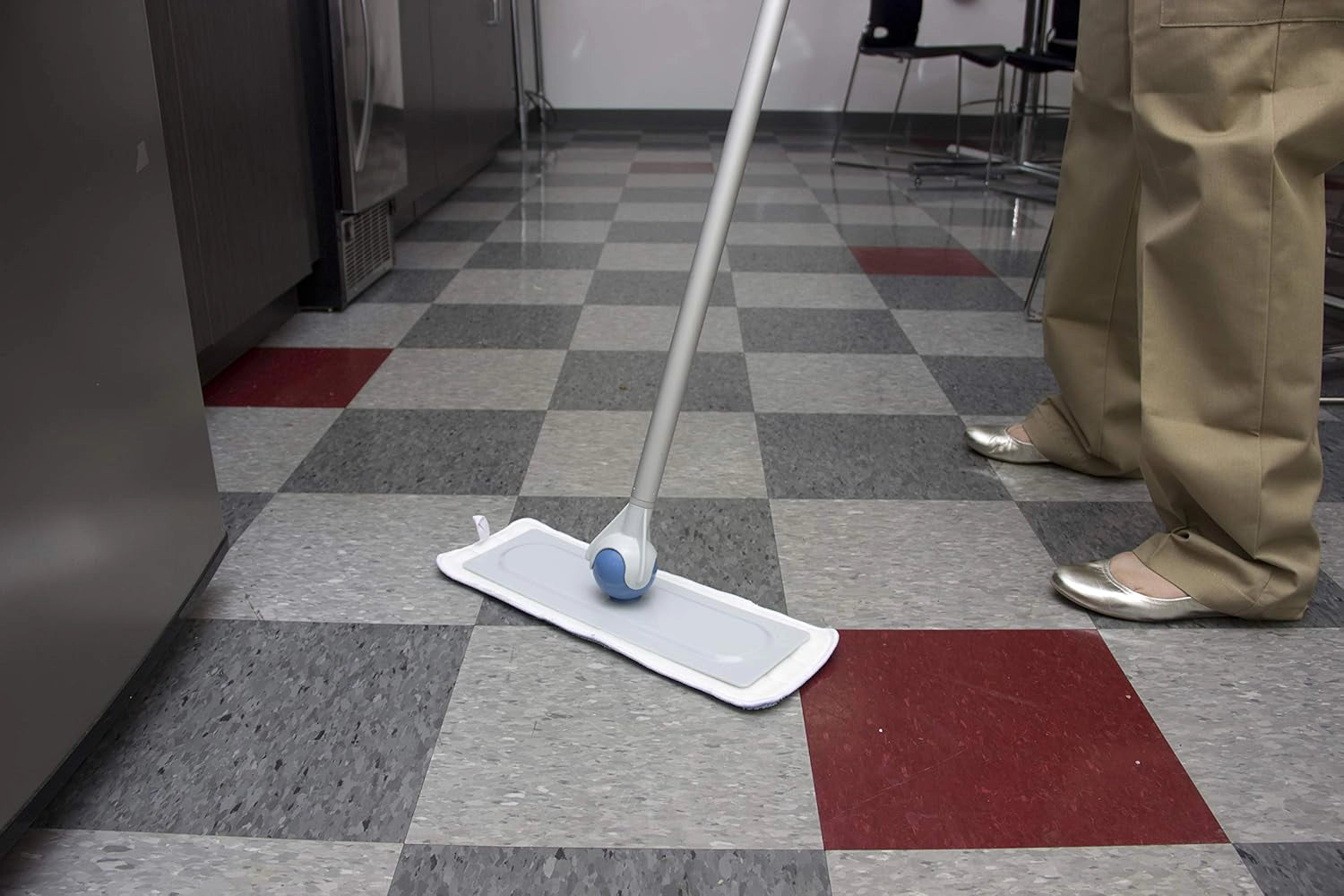 Sphergo mop in use cleaning hardwood floor with spherical handle and pole