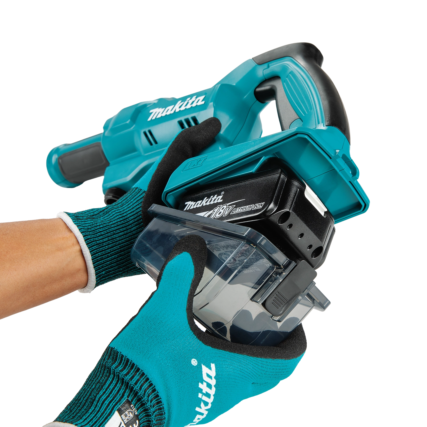 Makita power tool held by a person wearing green gloves on a white background