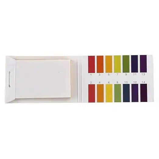 Open pH test strip booklet showing unused white strips and color key