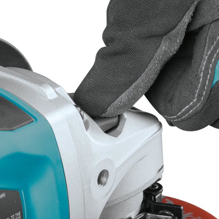 close up of makita 5 inch grinder lock on button and paddle switch
