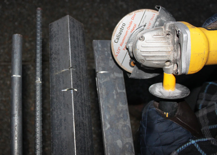 Angle grinder with Caliastro wheel slicing through a steel rod during fabrication
