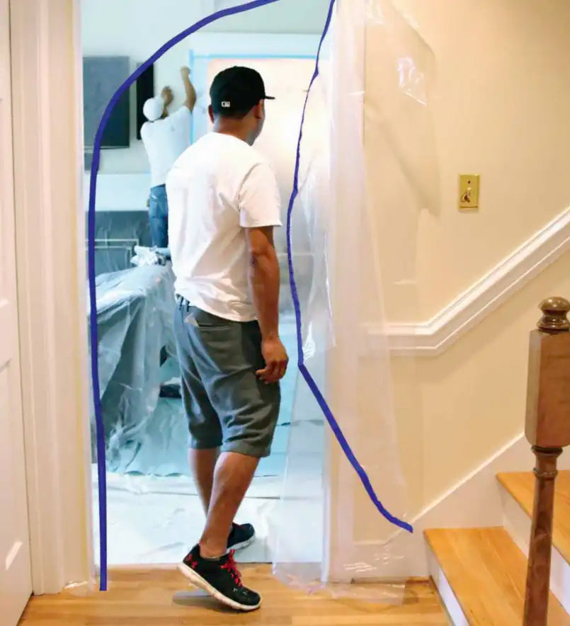 Contractor entering a plastic dust barrier with heavy-duty zipper installed
