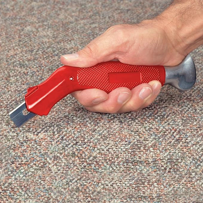 Cut & Jam carpet knife held in hand to show grip comfort and size
