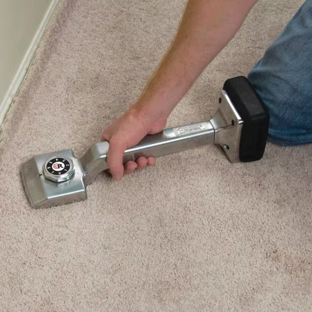 Installer using the Deluxe Knee Kicker to stretch carpet into position
