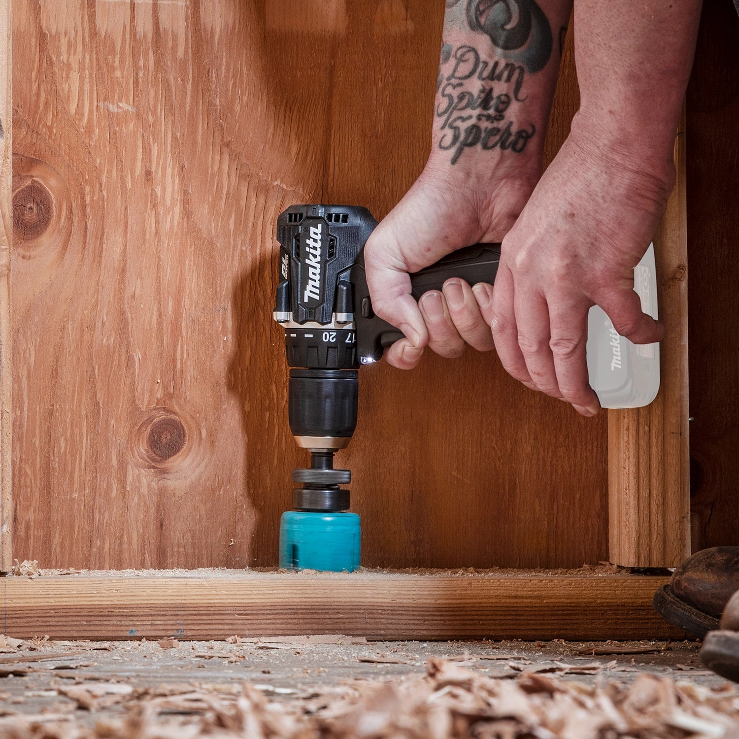makita sub compact drill drilling into wood framing for construction
