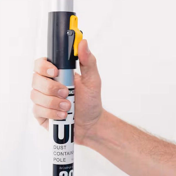 Close-up of hand engaging yellow thumb clip on E-Z UP support pole for height locking
