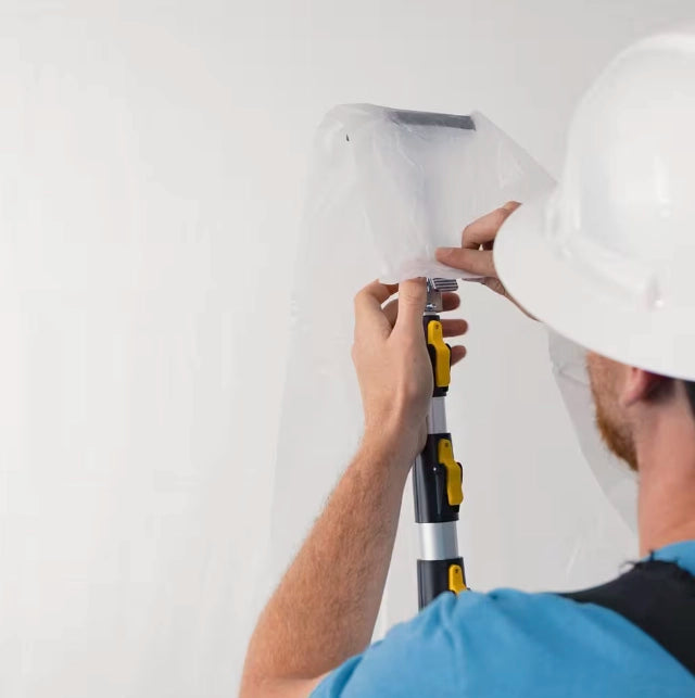 E-Z UP 20-foot poles on job holding up barrier sheeting for dust control
