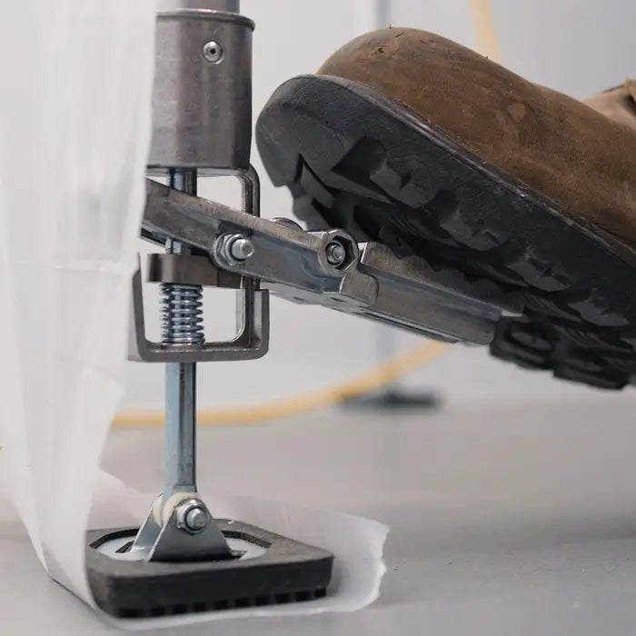 Close-up of E-Z UP pole foot pedal used to lock the base against floor or ceiling
