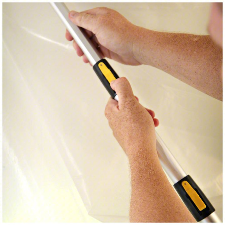 E-Z UP pole in use supporting plastic sheeting at a construction site containment zone
