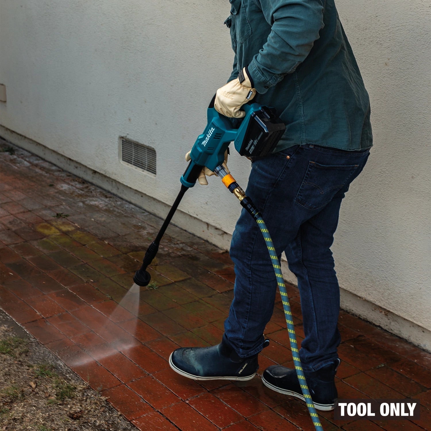 Person using a pressure washer tool on a brick surface with 'TOOL ONLY' text.