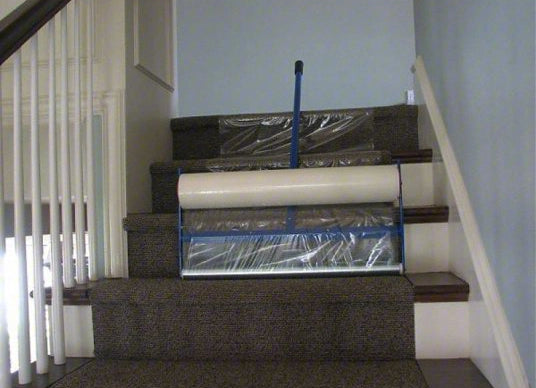 Trimaco Film Applicator in use while applying film on stair treads
