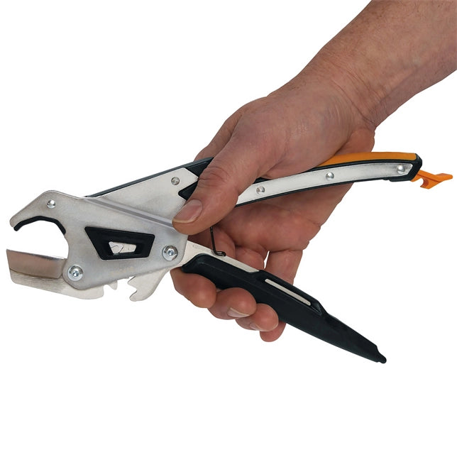 Fiskars Pro Cutter in use cutting through PVC pipe during plumbing job
