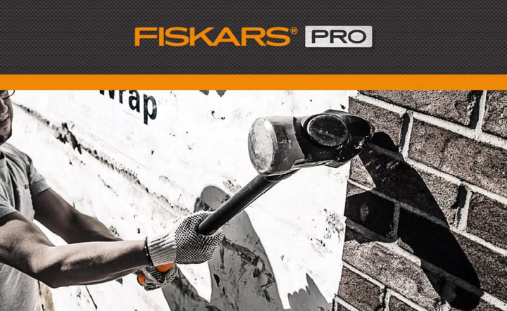 Using Fiskars IsoCore sledge hammer to demolish concrete wall
