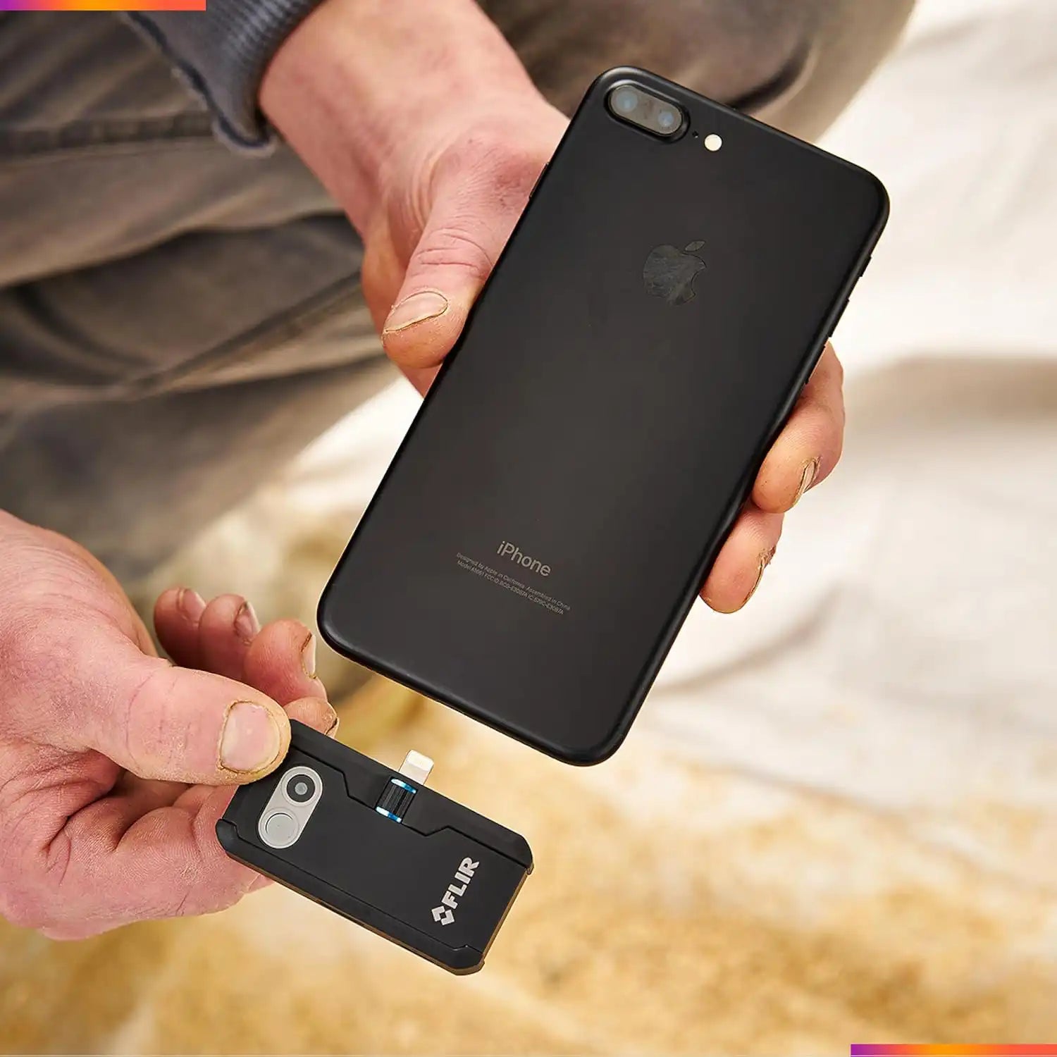 FLIR ONE Pro thermal camera for iOS being connected to an iPhone by a technician in the field
