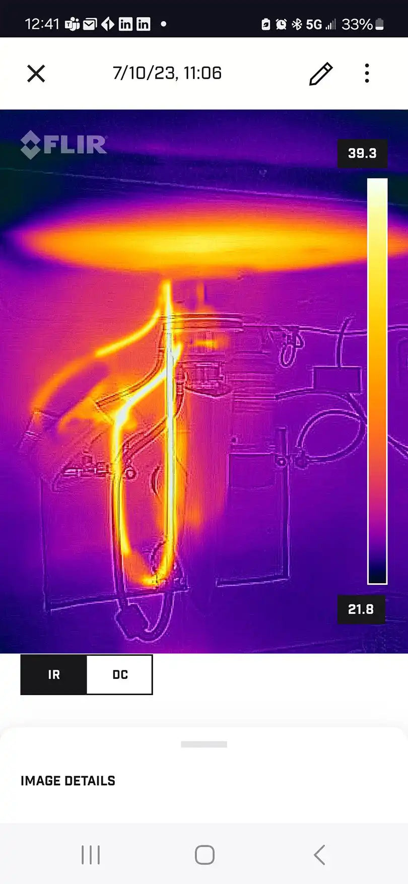 Thermal image captured with FLIR ONE Pro showing heat variance in electrical wiring on smartphone screen
