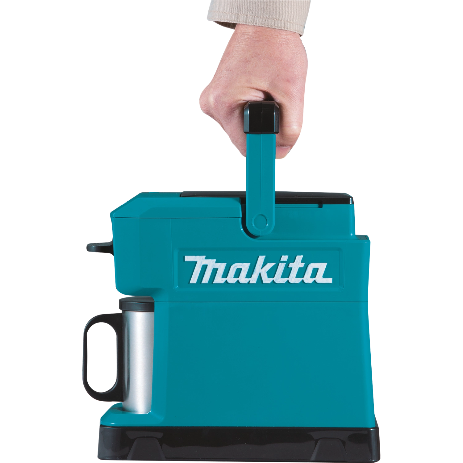 holding makita coffee maker handle up while walking on job site
