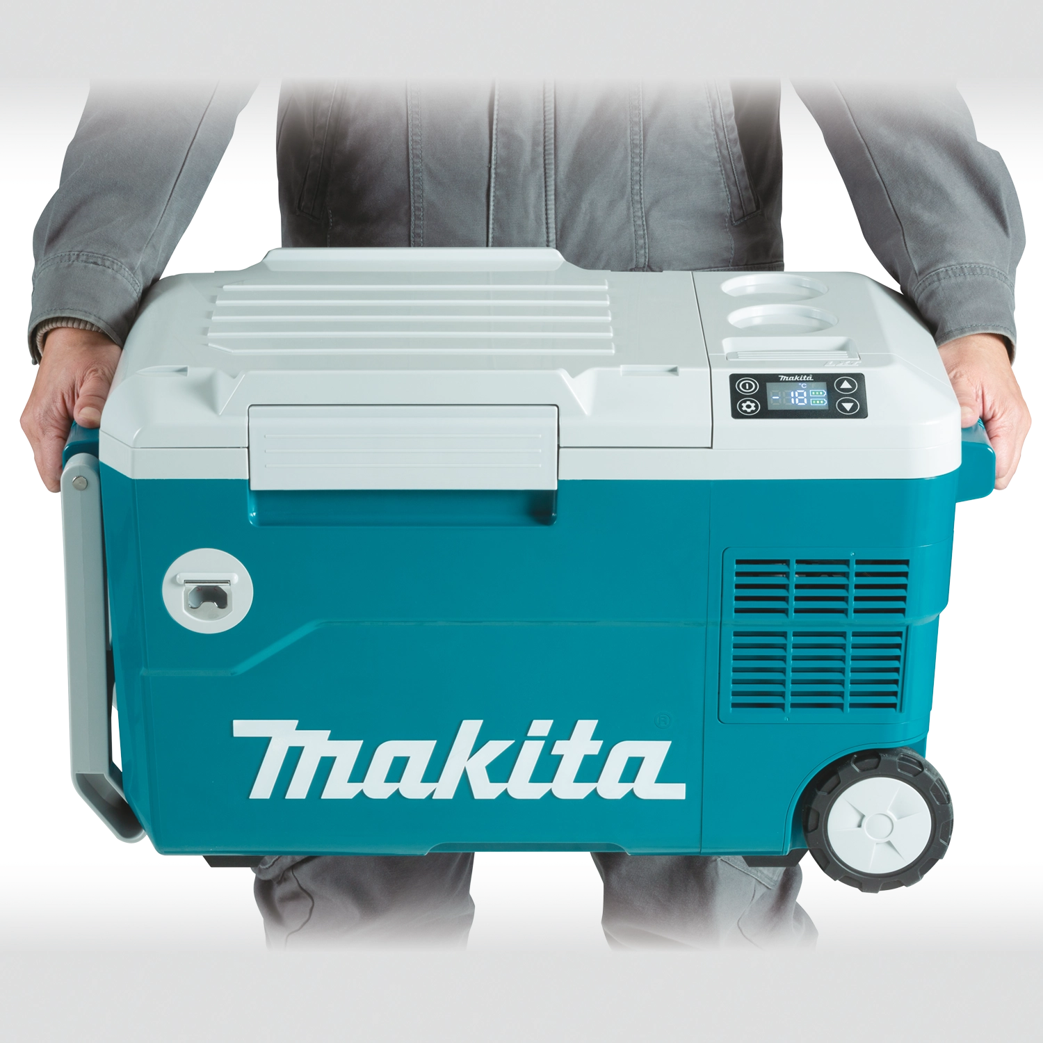 user holding makita cooler warmer box by side handle for manual transport
