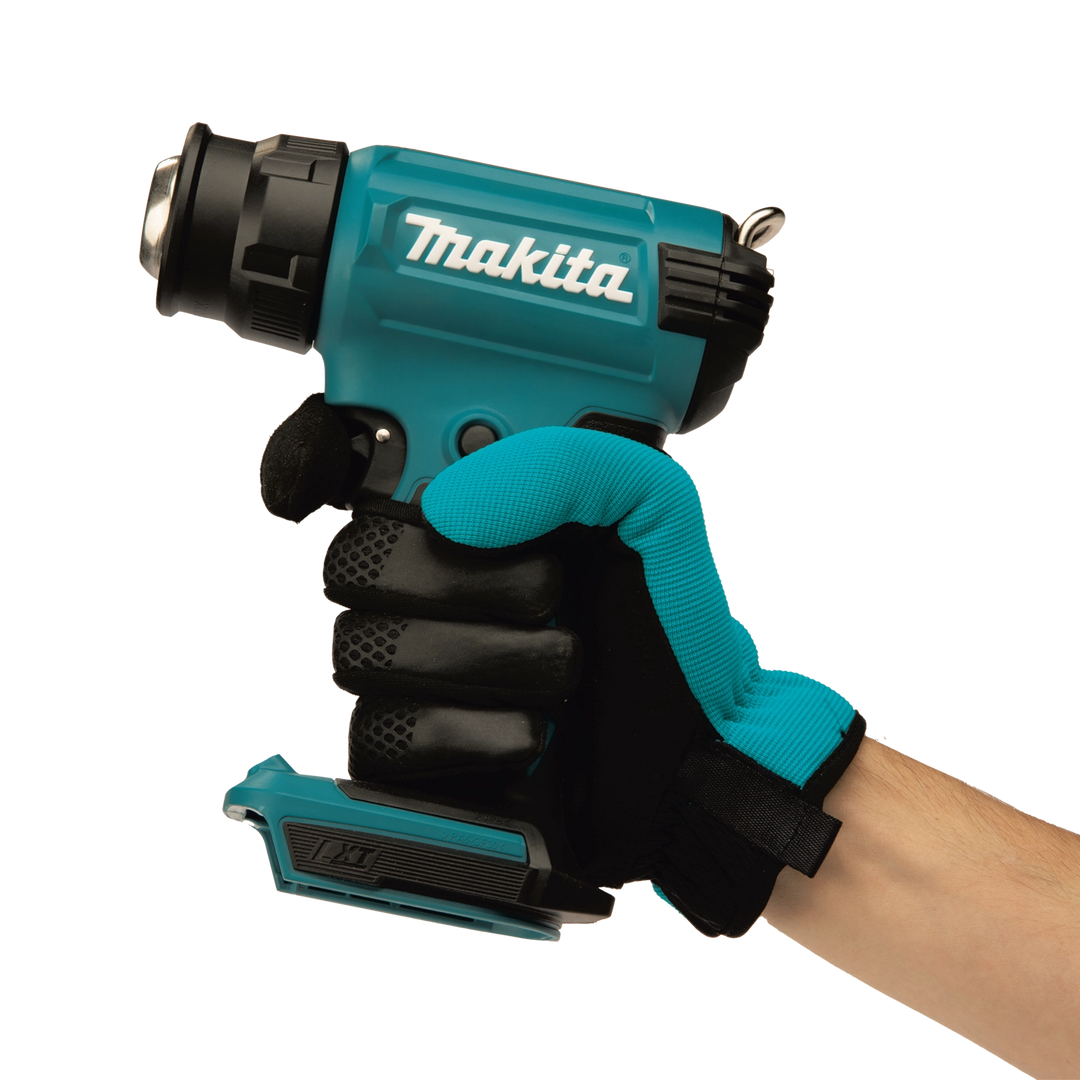 user holding makita cordless heat gun during application for hands-on control
