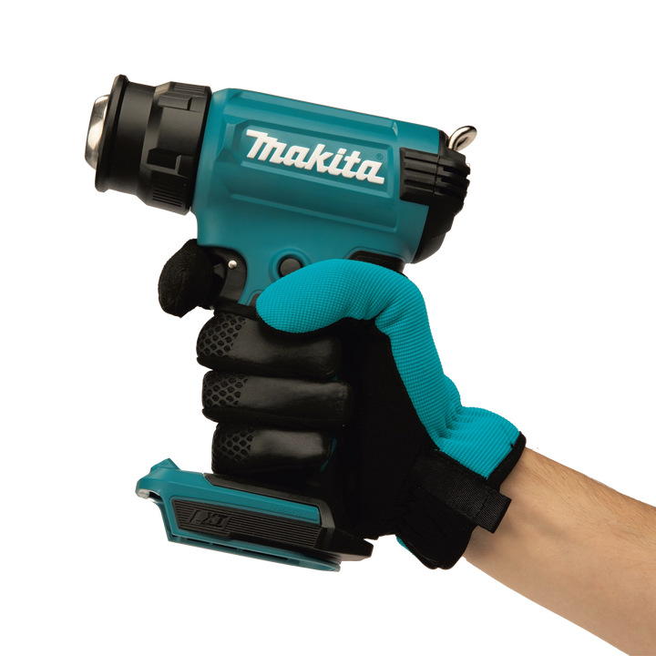 user holding makita cordless heat gun during application for hands-on control

