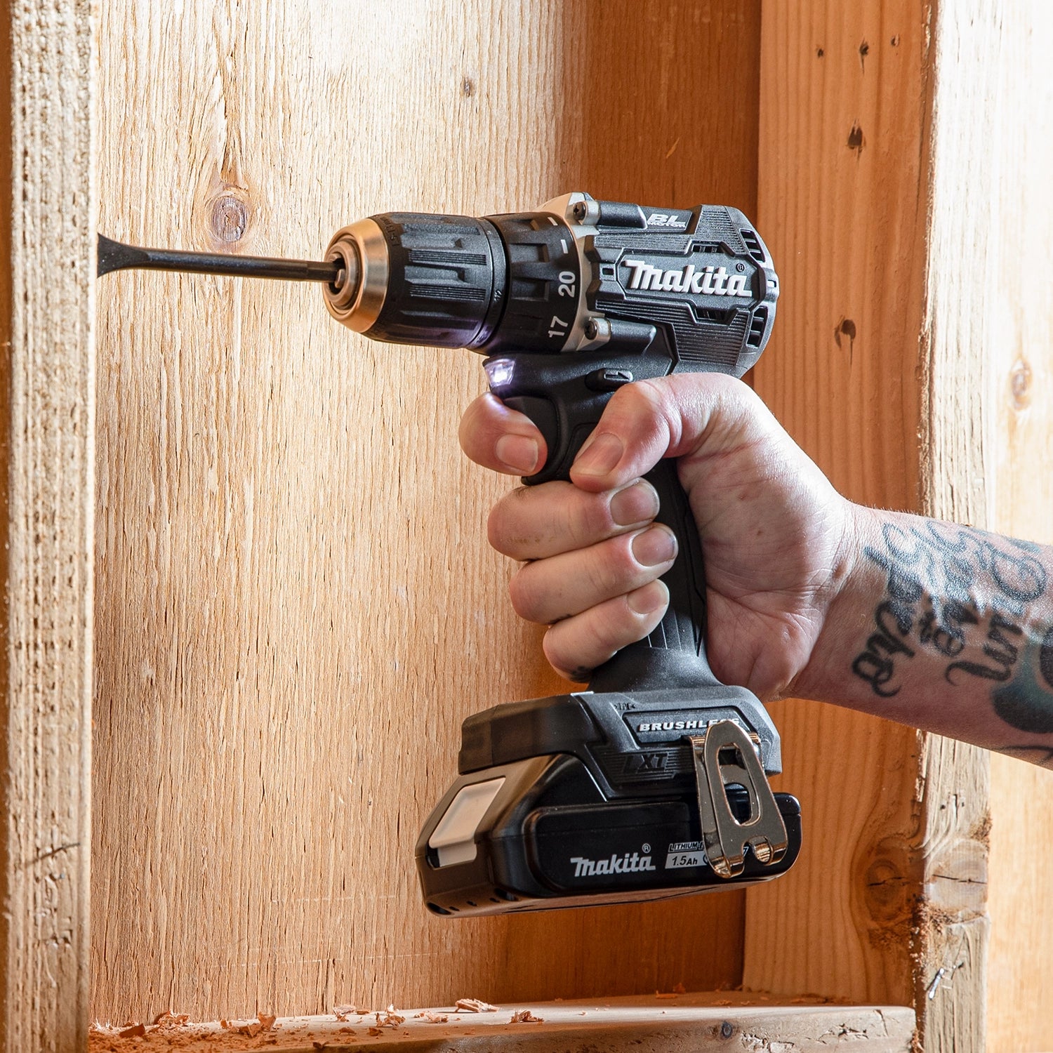 worker holding makita 18v lxt sub-compact drill showing ergonomic design and grip
