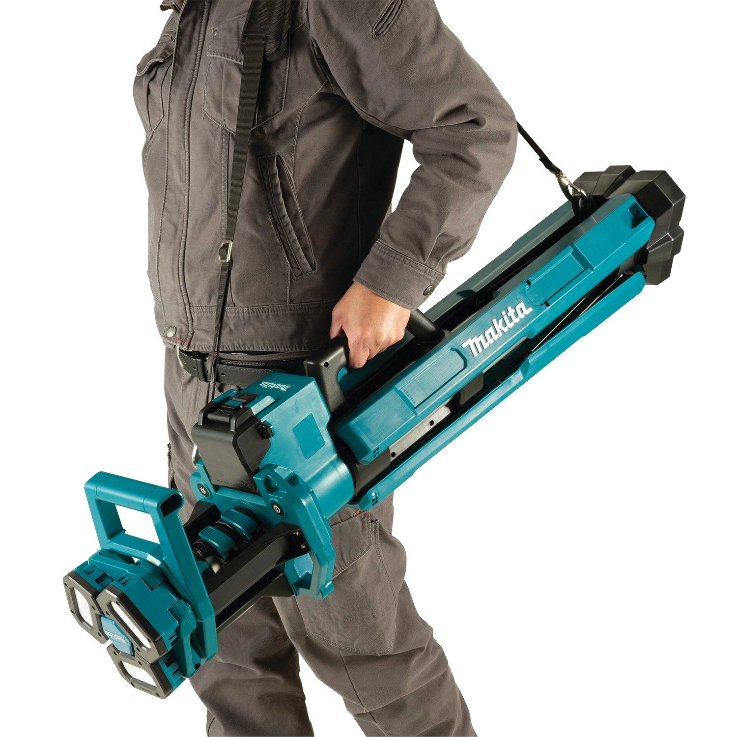 worker holding makita tower work light while adjusting height or positioning
