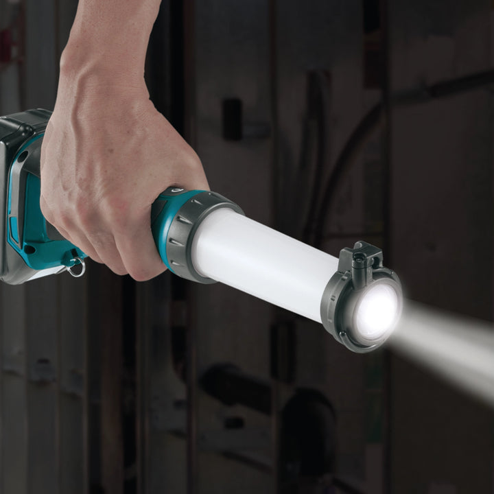 person holding makita lantern flashlight outward for focused lighting
