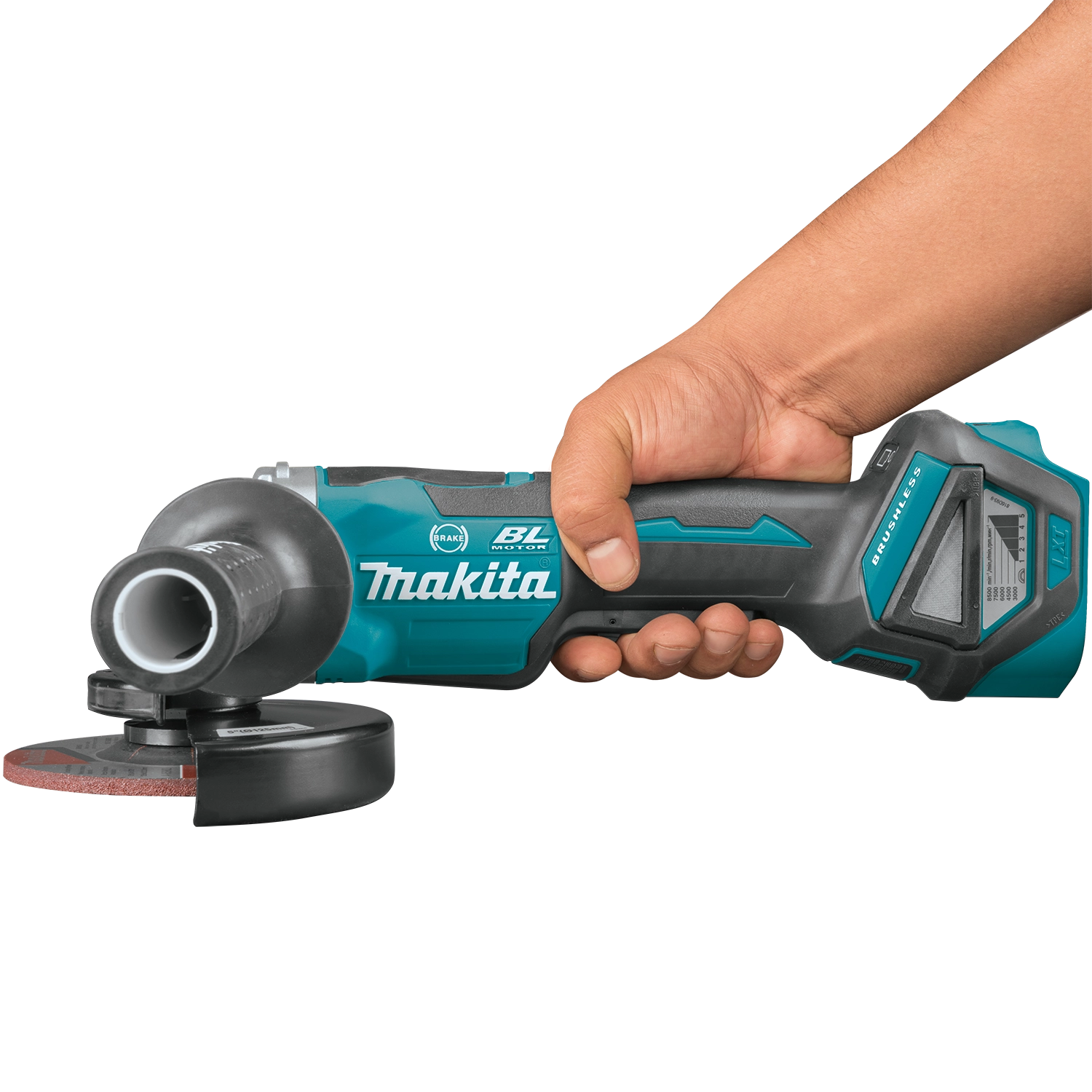 makita 18v lxt 5 inch grinder held to the side during grinding operation
