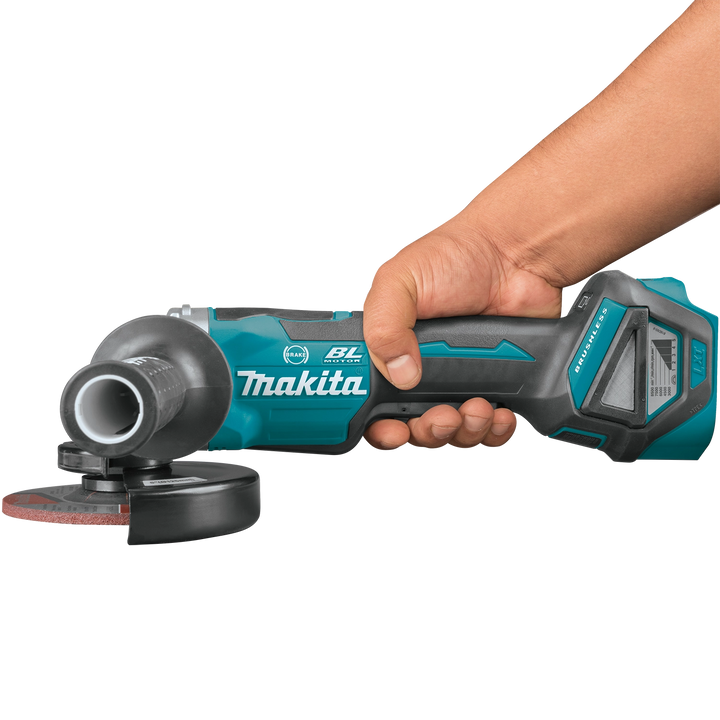 makita 18v lxt 5 inch grinder held to the side during grinding operation
