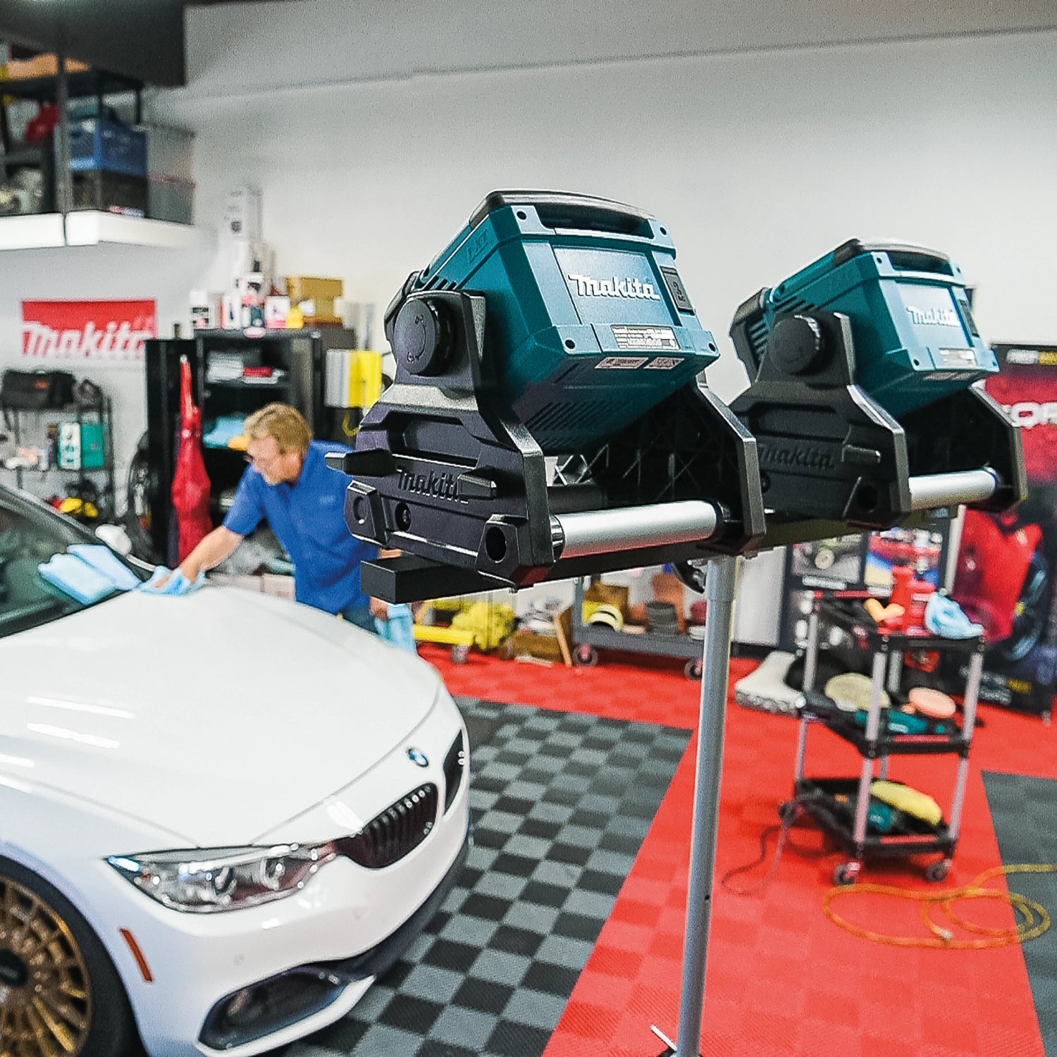 makita dml811 led work light in use inside car shop for automotive repairs
