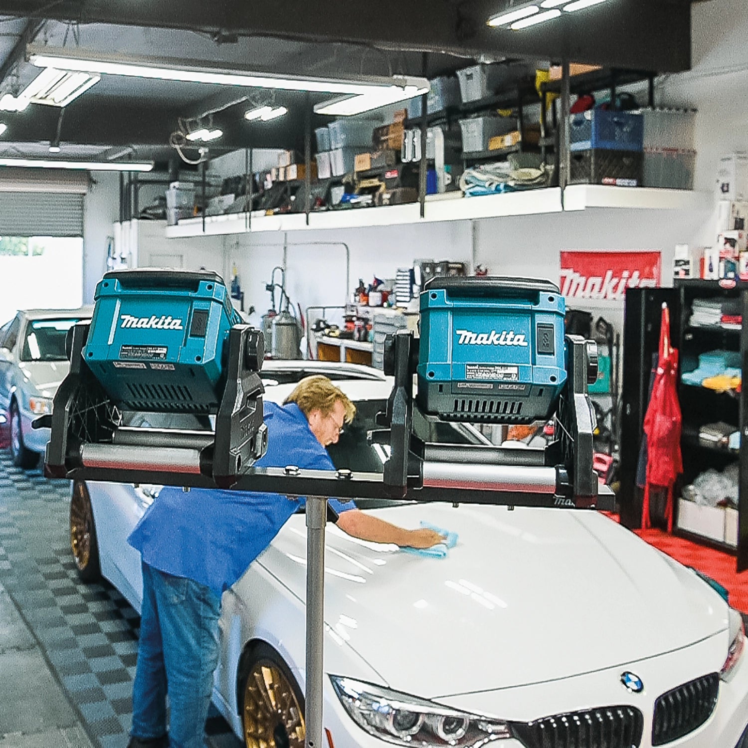 makita led work light illuminating workspace inside auto shop for detailed tasks
