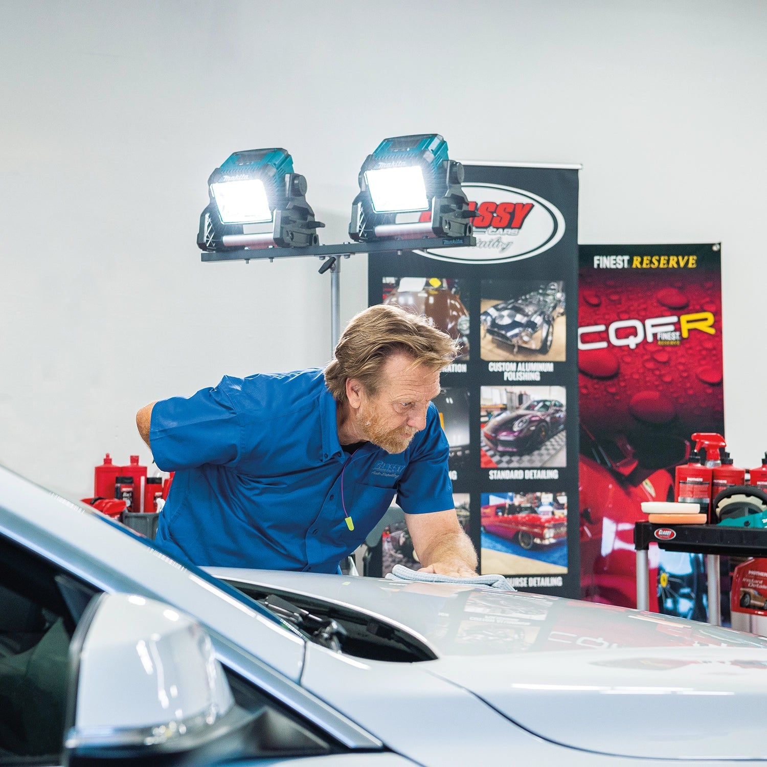 makita led work light used in automotive bay highlighting undercarriage repairs
