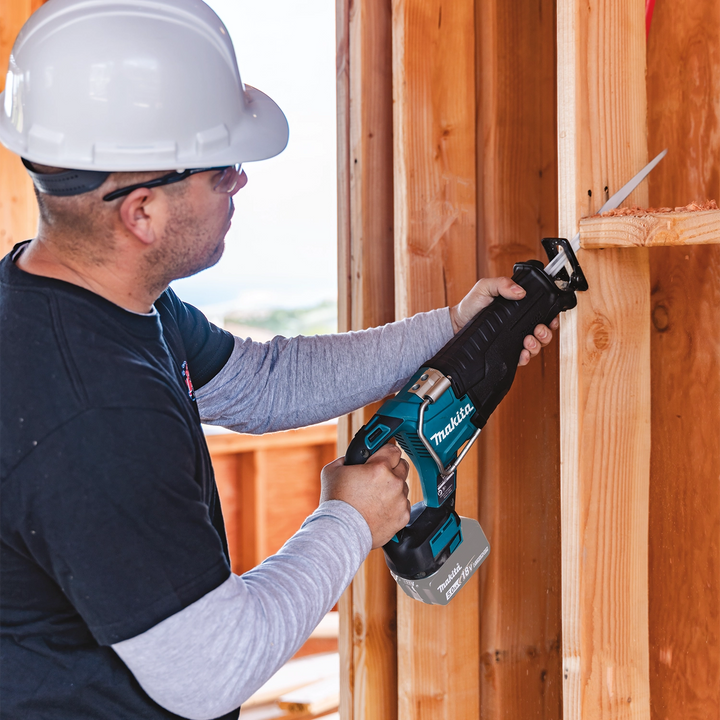makita 18v lxt reciprocating saw in use cutting wood on construction site
