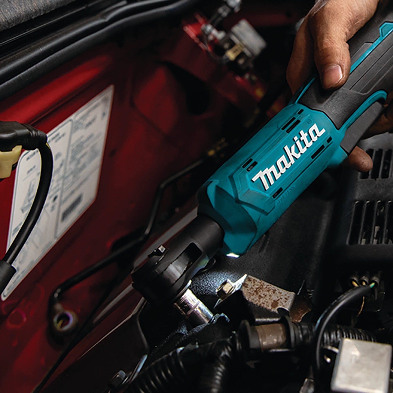 professional using makita xrw01z ratchet on electrical cabinet at job site
