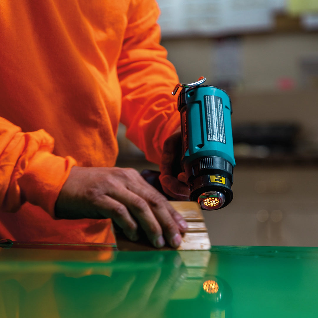 makita 18v lxt heat gun in use applying heat to shrink wrap or loosen adhesive
