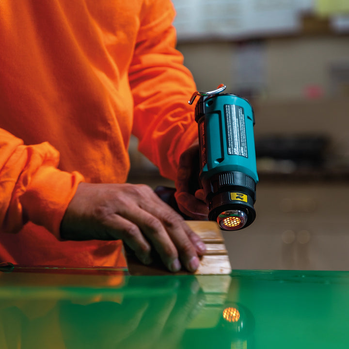 makita 18v lxt heat gun in use applying heat to shrink wrap or loosen adhesive
