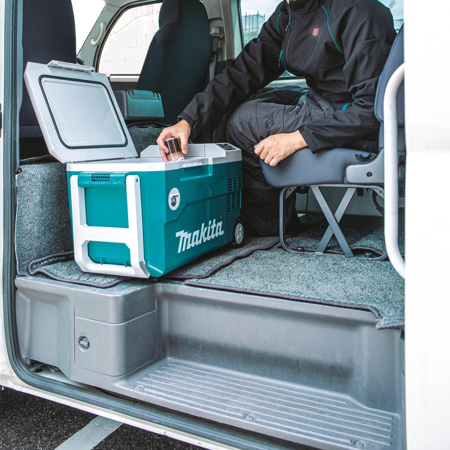 makita cooler warmer box stored inside work van for mobile use
