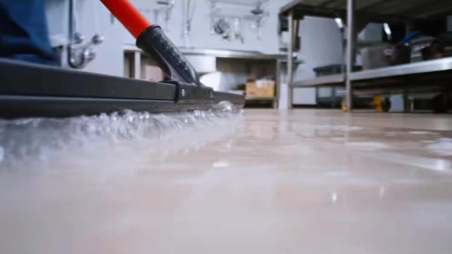 Libman 24 inch squeegee on indoor floor surface near spilled water
