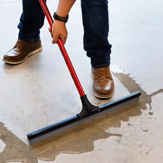Libman squeegee in action removing standing water from smooth floor
