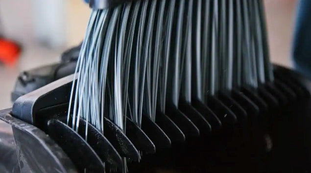 Close-up of Libman dust pan teeth designed to clean broom bristles
