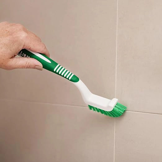 Libman grout brush in use on a tiled floor at a job site
