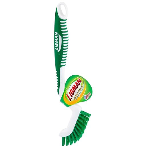 Libman grout brush standing upright on flat surface
