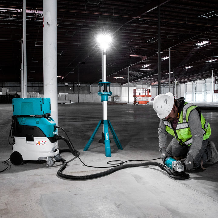 makita tower work light fully illuminating construction job site during late hours
